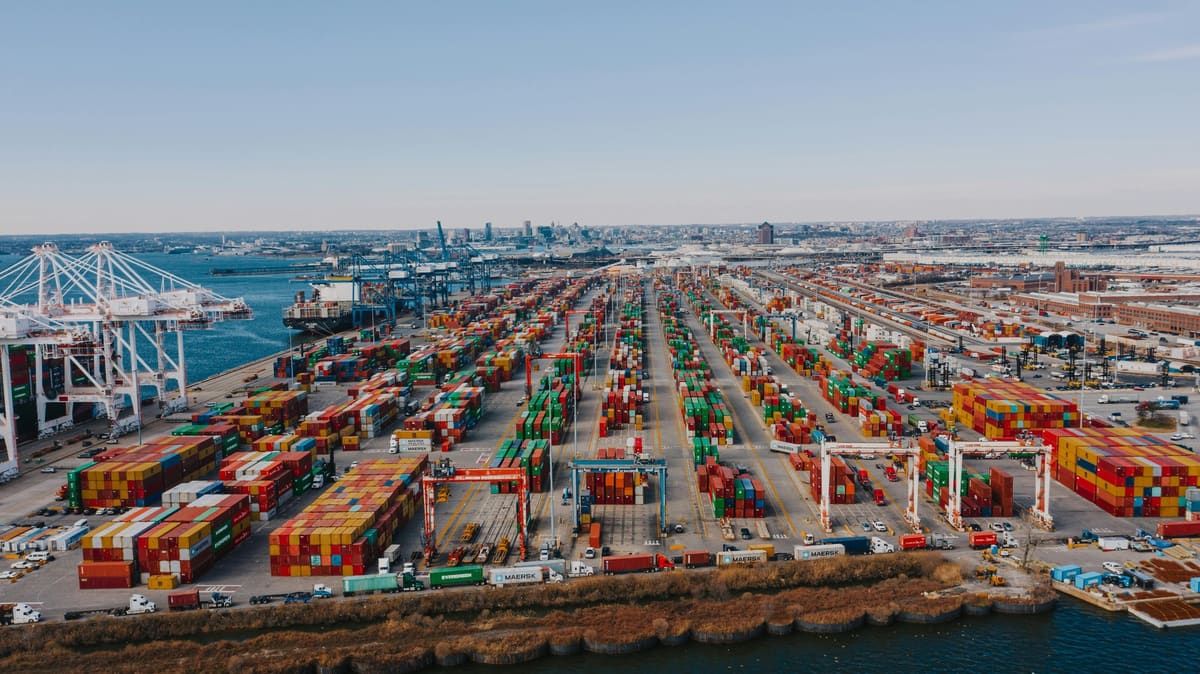 Container ships docked at port terminal showing national logistics hub operations